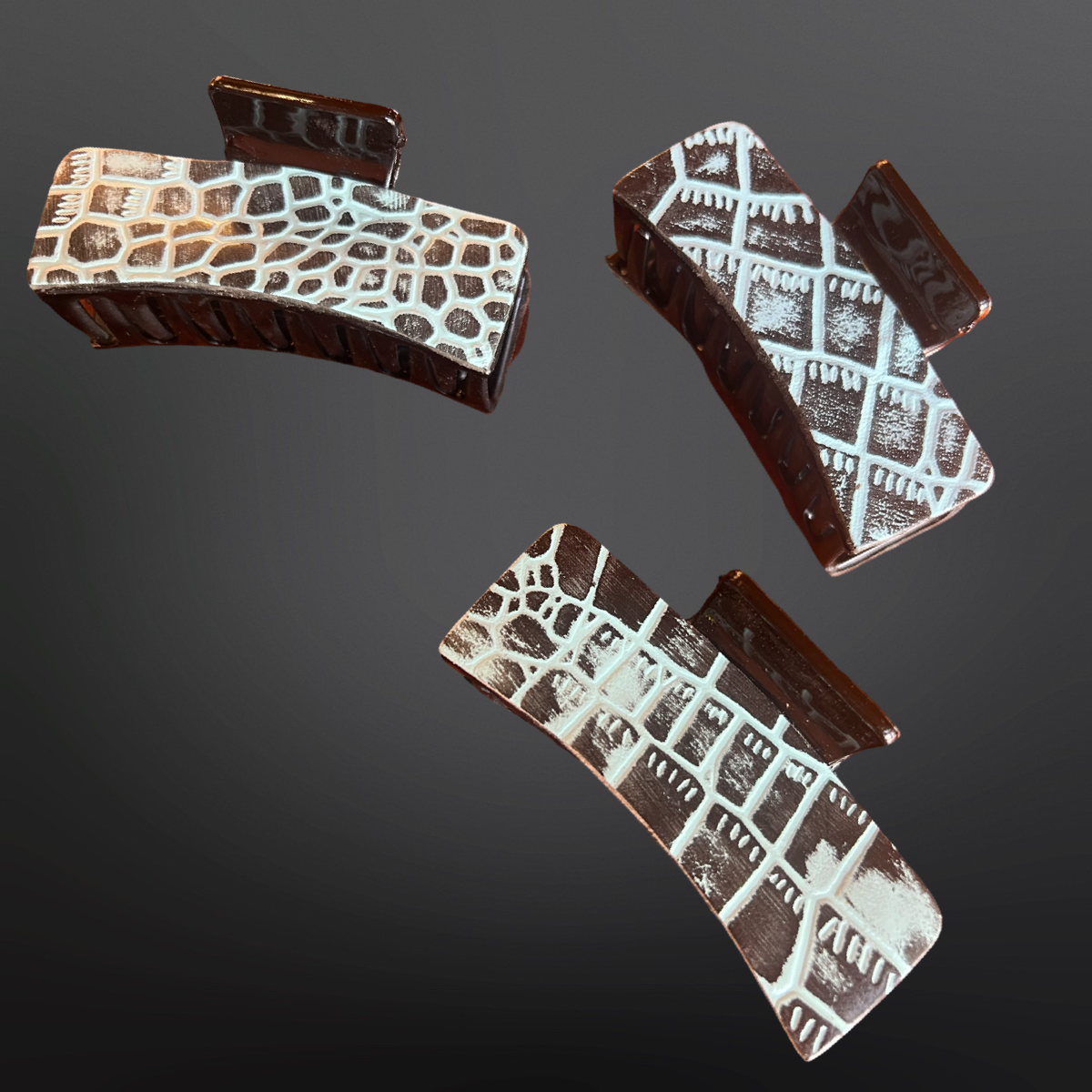 Embossed hair clips  on a dark background