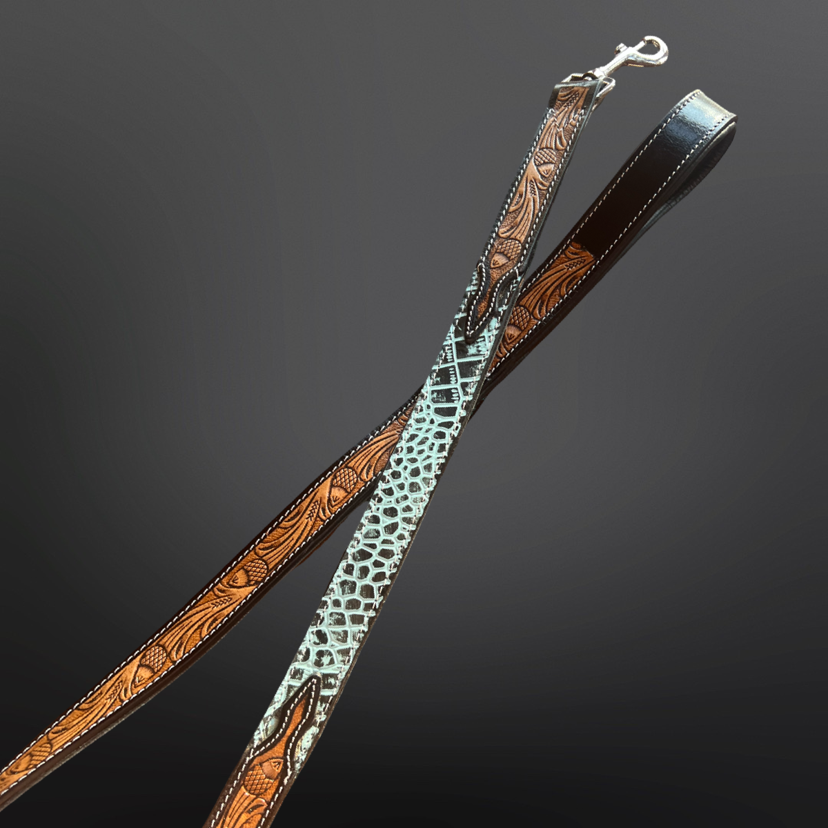 Tooled leather dog leash with turquoise embossed leather shown on a dark background. 