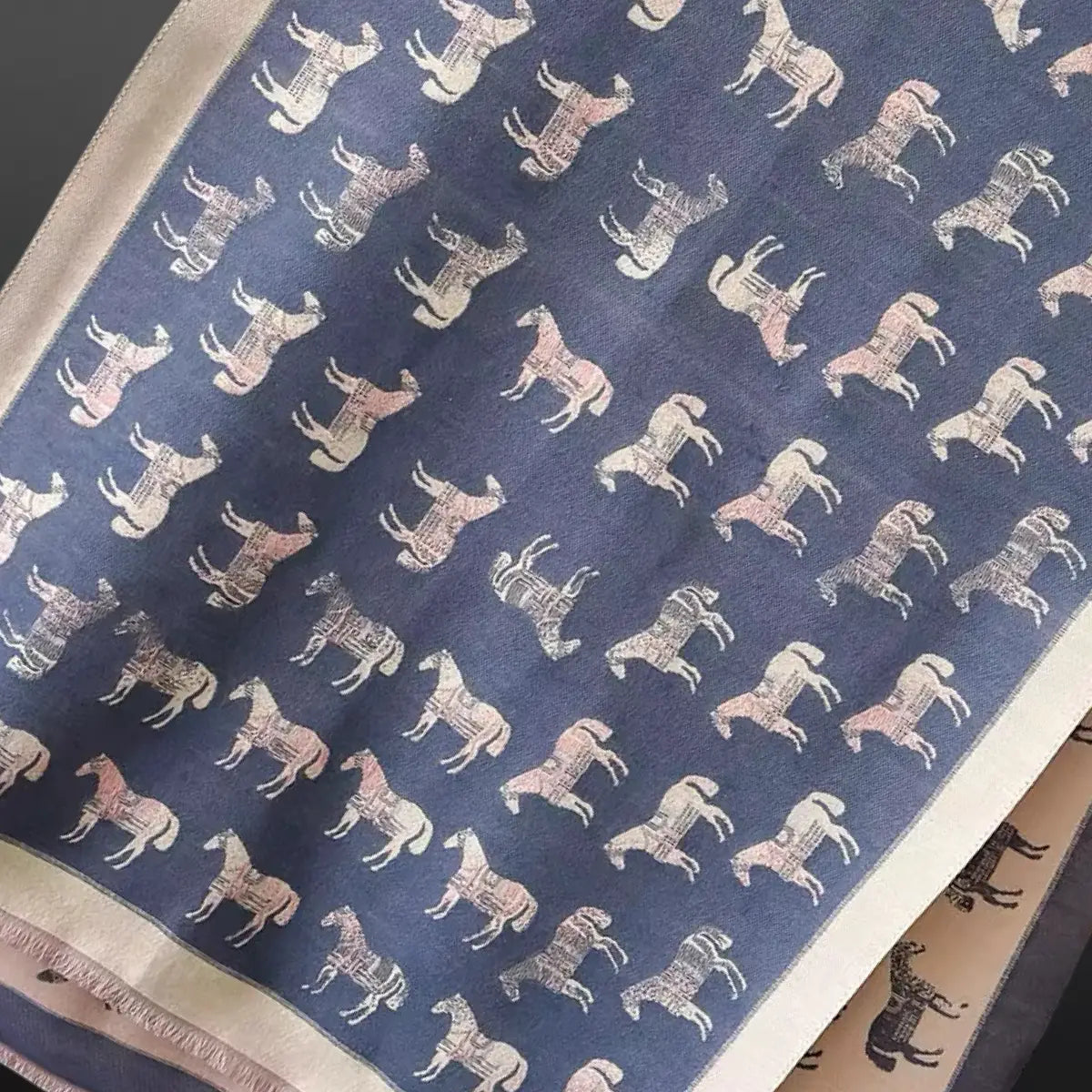 Scarf with a pattern of horses on a blue background