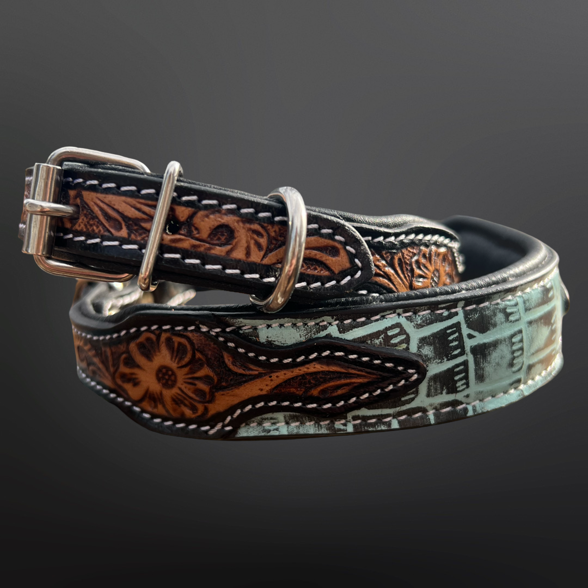 Decorative leather dog collar with intricate patterns on a dark background