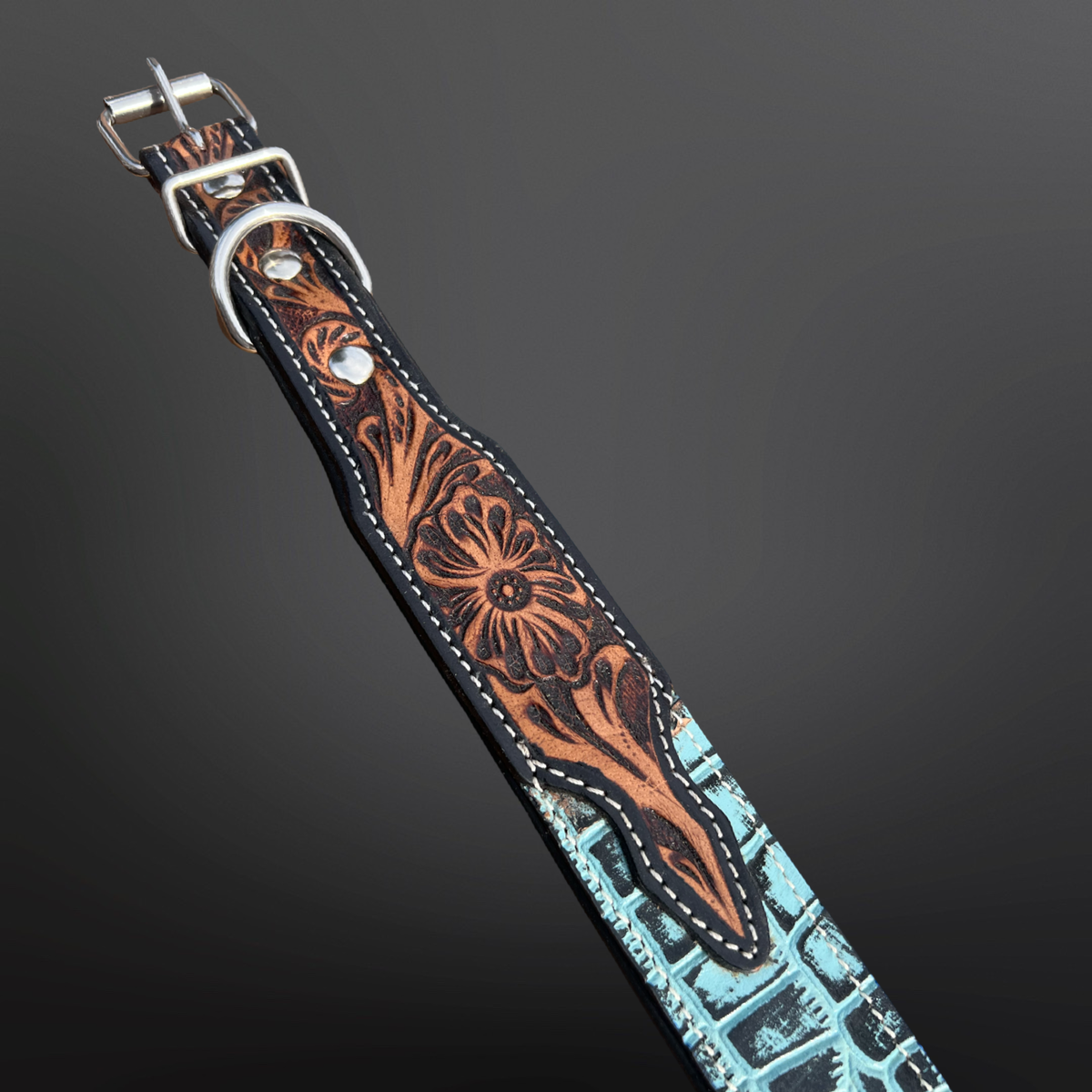 Leather dog collar with floral patterns on a dark background