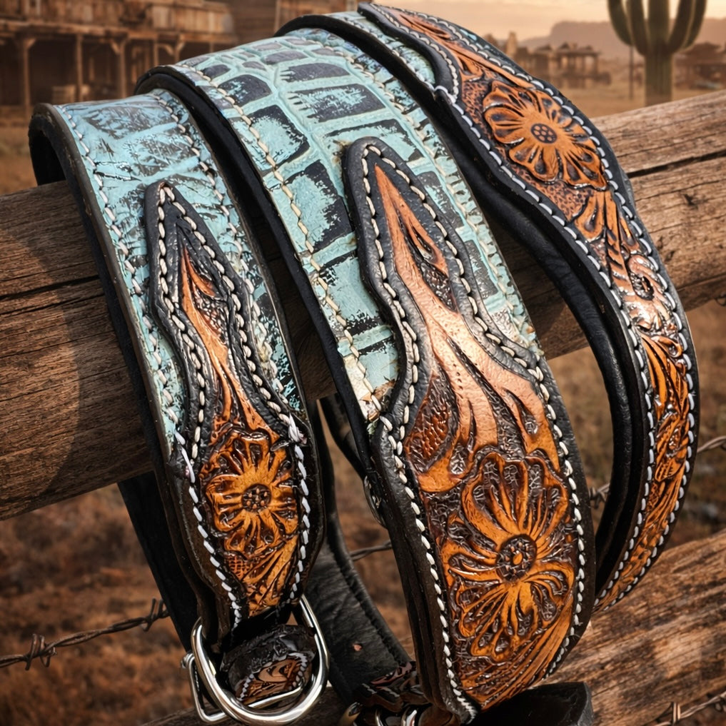 Western leather dog collar with intricate patterns on a wooden post against a desert background.