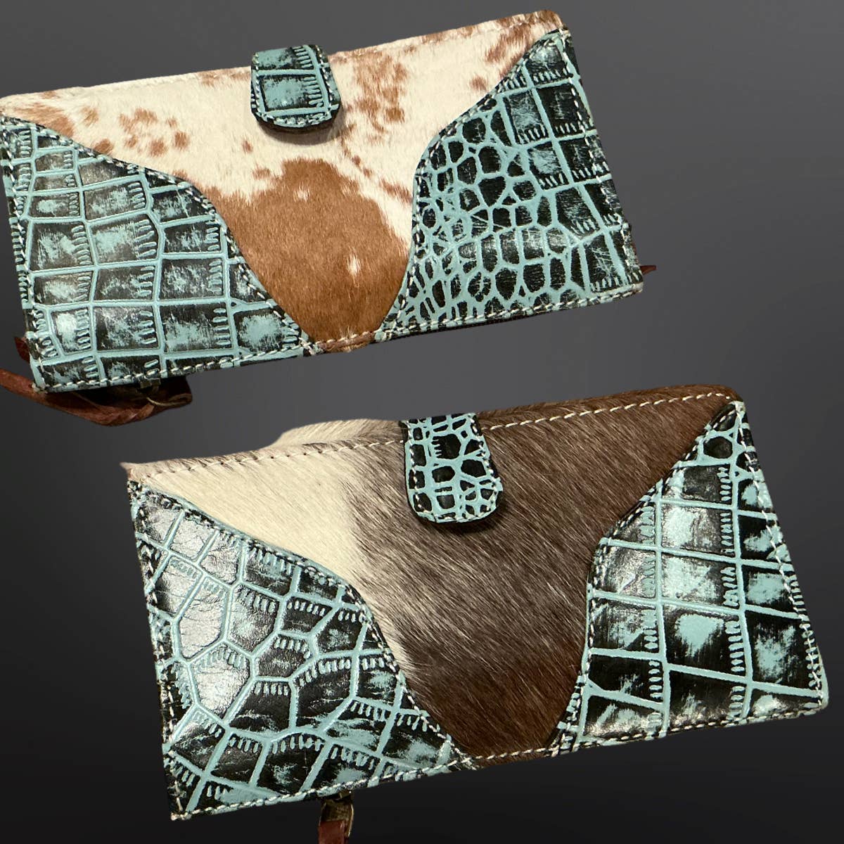 Two cowhide leather clutch bags with geometric pattern on a dark background