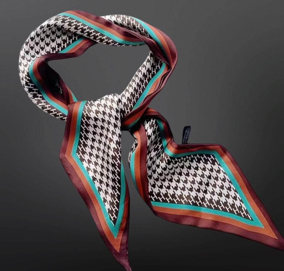 Patterned scarf with houndstooth and geometric design on a dark background