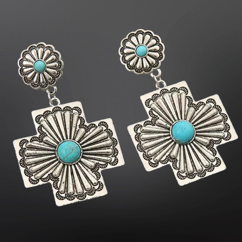 Silver earrings with turquoise stones on a black background